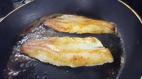 Frying zander or pike-perch fillets, on a frying pan Stock Footage 63213554