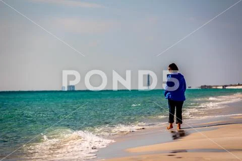 Ft Beautiiful woman walking on a sunny white sand beach 1014-51 Stock Photos