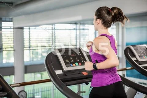Fti brunette running on treadmill Stock Photos