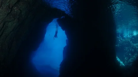 Ftree diver in underwater cave diving freedom apnea sport snorkeller Stock Footage 114825637