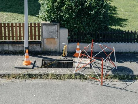 FTTH Optical Fiber Setup in Progress: City Sidewalk Stock Photos