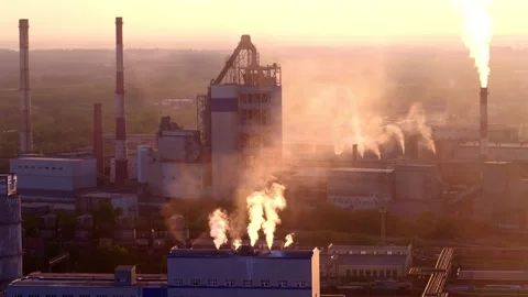 Fuel - energy complex against the sunset. Smoke rises up from the factory pipes Stock Footage 156980700