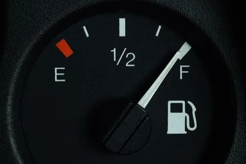 The fuel level indicator on the dashboard is at the full tank mark, close-up Stock Photos