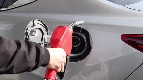 Fuel nozzle is getting inserted into automobile's tank. Fuel, gas station, ho Stock Footage 256723757