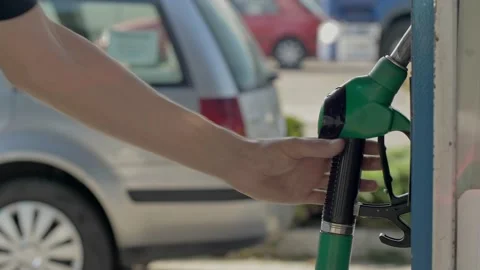 Fuel nozzle getting put into its place. Fuel, gas station, petrol prices concept Stock Footage 133841780
