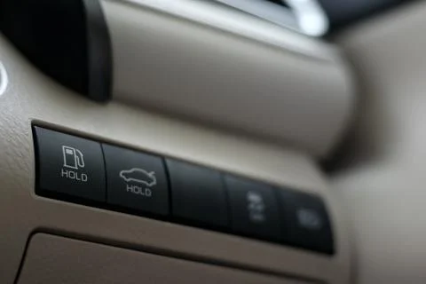 Fuel tank cap opening button on dashboard, car gas tank door release switch Stock Photos
