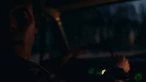 Fugitive inside his car in the evening looking back Video stock 283105025