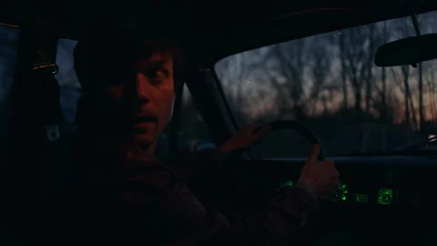Fugitive inside his car in the evening Stock Footage 283105125