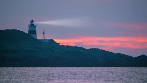 Fugui Cape Lighthouse at sunset in Shimen, New Taipei City, Taiwan Stock Footage 340556018