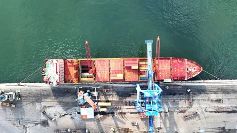 Full aerial view of freighter, containers and queuing trucks unloading and Stock Footage 241793140