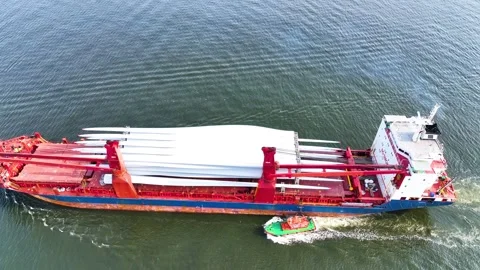 Full aerial view of red cargo ship carrying weather vane propeller, advancing Stock Footage 242760874
