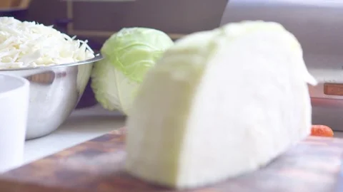 Full and chopped cabbage on kitchen worktop Stock Footage 76198610