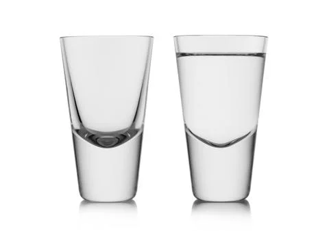 Full and empty shot glasses of pure clear cold vodka and tequila. Stock Photos
