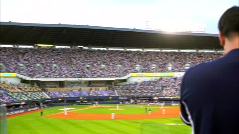 Full baseball stadium buzzes with cheering fans during live game. Scene captures Video stock 318872481