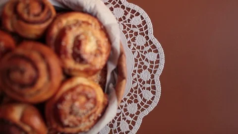 Full basket of sweet bread rolls with cinnamon and sesame seeds Stock Footage 72974121