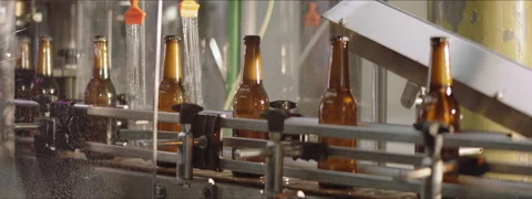 Full beer bottles in a washing process Stock Footage 147372565