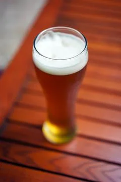 Full beer glass on a table Stock Photos