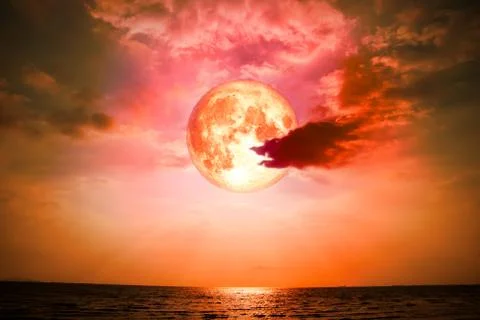 Full blood moon back silhouette cloud on the horizonal line in sea Stock Photos