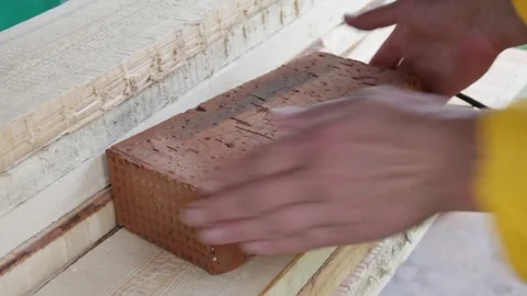 Full-bodied red building bricks in the hands of the worker Video stock 77198134