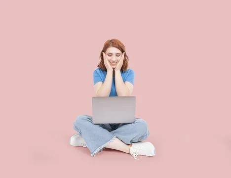 Full body front view young 20s woman sit floor legs crossed hold use laptop Stock Photos