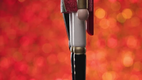 Full body presenatation of a spinning Nutcracker on a beautiful bokeh red and Stock Footage 321679853