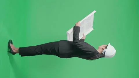 Full Body Side View Of Smiling Asian Female Engineer Looking At Blueprint Before Stock Footage 186115487