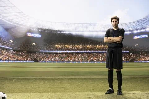 Full body view portrait of referee in black uniform standing with arms crossed Stock Photos
