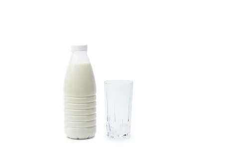 Full bottle of milk and an empty glass isolated on a white background Stock Photos