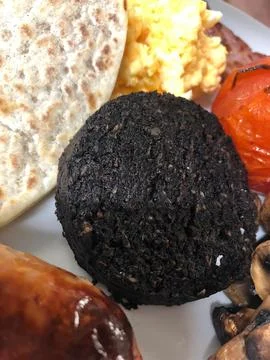 Full Breakfast with Black Pudding, Scrambled Egg, and Grilled Tomato Stock Photos