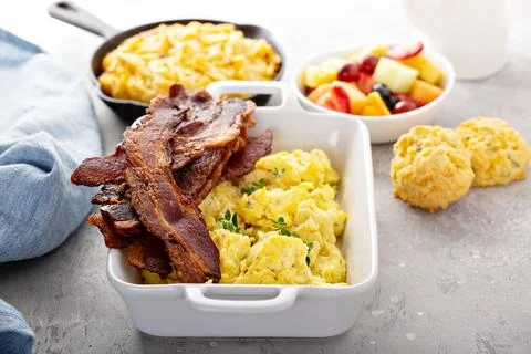 Full breakfast with scrambled eggs, bacon and potatoes Stock Photos