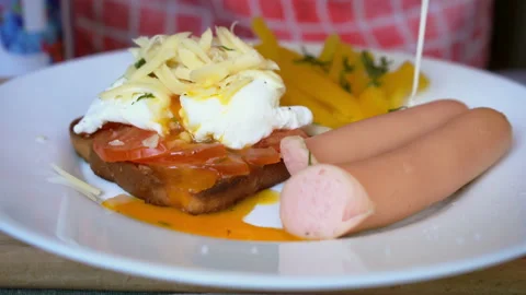 Full breakfast with toast, poached egg and cheese, sausages and vegetables salad Stock Footage 133156204