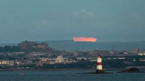The full Buck moon rising up behind Edinburgh castle Stock Footage 245210951