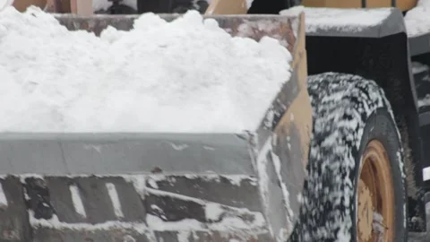 A full bucket of snow at a construction loader, snow removal equipment in winter Stock Footage 253472833