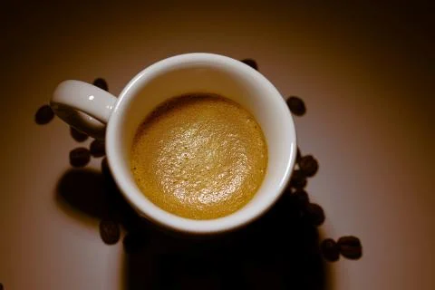 Full coffee cup on brown background Stock Photos