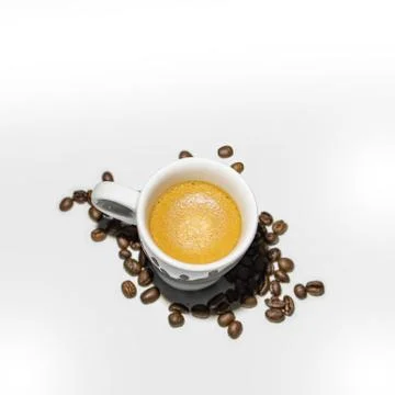 Full coffee cup on white background with beans Stock Photos