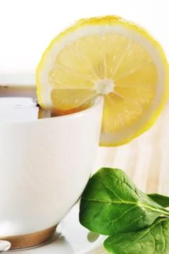 Full cup of tea with lemon Stock Photos