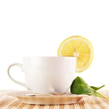 Full cup of tea with lemon Stock Photos