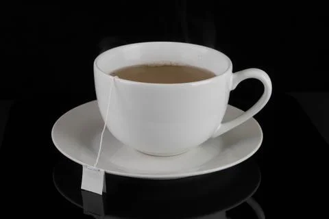 Full Cup of Tea in White Cup with Tea Bag Stock Photos