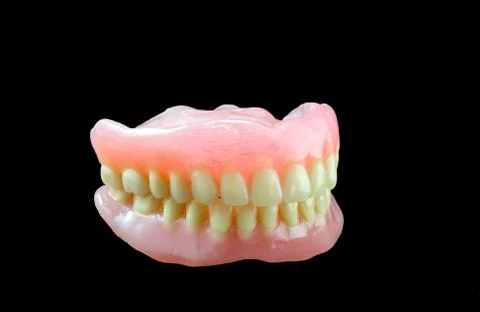Full denture on black background Stock Photos