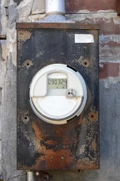 The full of the digital electric meter on the old metal cabinet. Stock Photos
