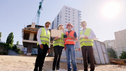 Full equipment engineers and architect in the middle of construction site they Stock Footage 146607128