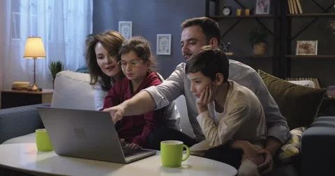 Full family using laptop computer browsing through websites, social media. Happy Stock Footage 272173651