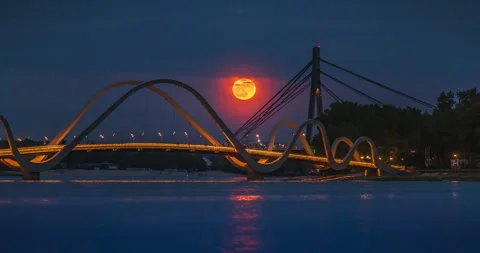 The full Flower Moon rises over the pedestrian bridge in Kyiv, Ukraine Stock Footage 309205422