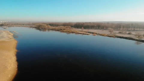 Full-flowing navigable river in the soft spring sun. Aerial shot Stock Footage 105460799