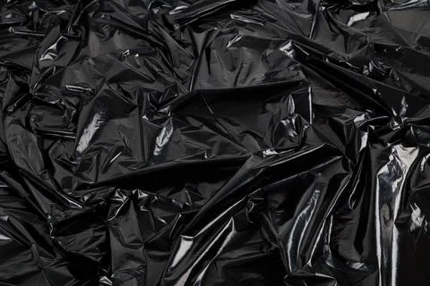 Full frame abstract background of crumpled black plastic film bag Stock Photos