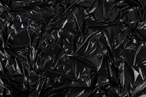 Full frame abstract background of crumpled black plastic film bag Stock Photos