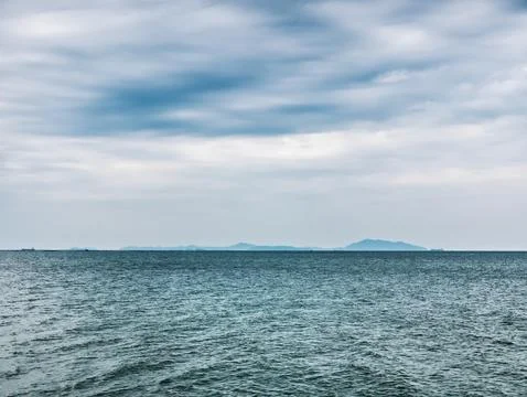Full Frame Background of Dark Blue Sea and Cloudy Sky with Horizon Stock Photos