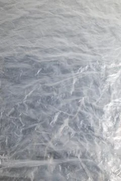 Full frame background of flat crumpled semi-transparent polyethylene film Stock Photos