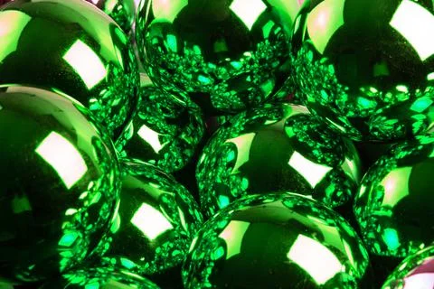 Full frame background of green mirror balls close-up with selective focus Stock Photos