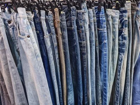 Full Frame Background of Hanging Denim Jeans for Sale Stock Photos